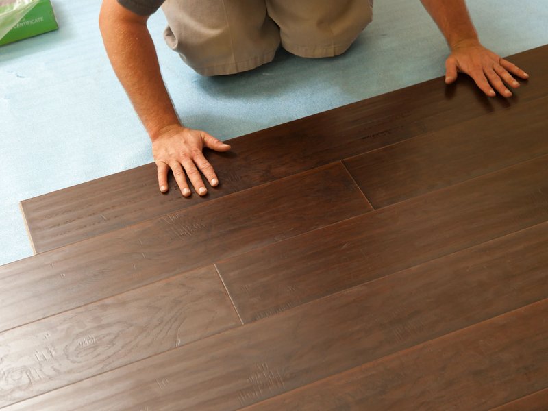person installing hardwood floor