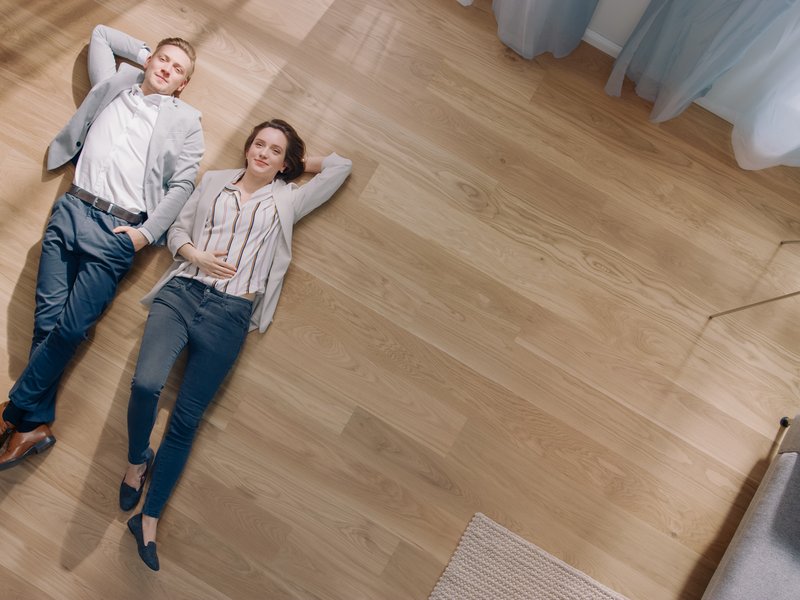 couple laying on the floor of their home